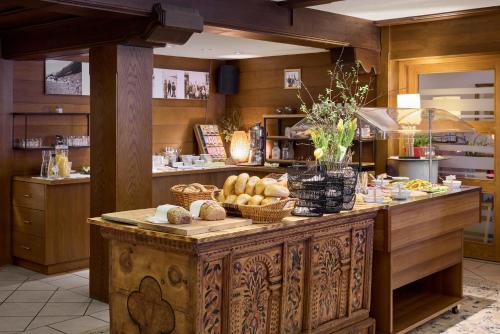 a kitchen with a table with bread and baskets on it at Bio Hotel Stillebach in Sankt Leonhard im Pitztal