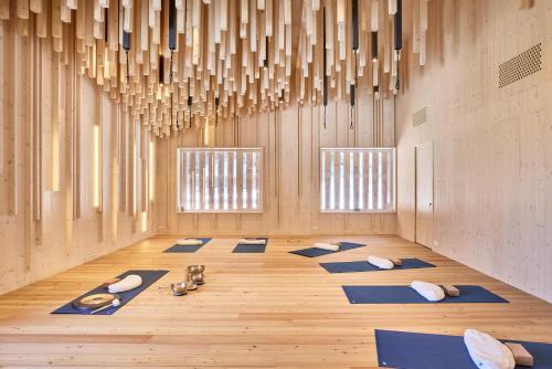 a room with yoga mats and chandeliers at Bio Hotel Stillebach in Sankt Leonhard im Pitztal