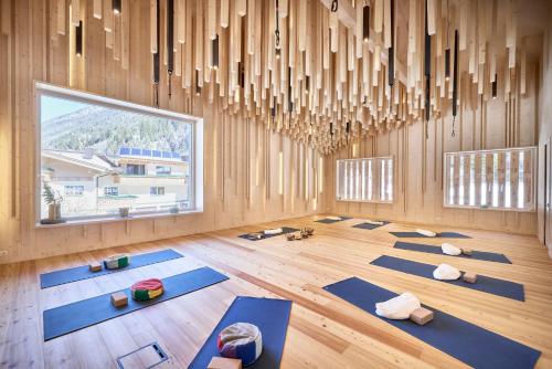 a yoga room with blue mats on the floor at Bio Hotel Stillebach in Sankt Leonhard im Pitztal
