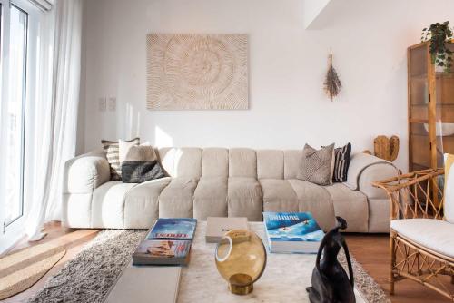 a living room with a couch and a table at Luxury Ocean View House - Central Ericeira in Ericeira