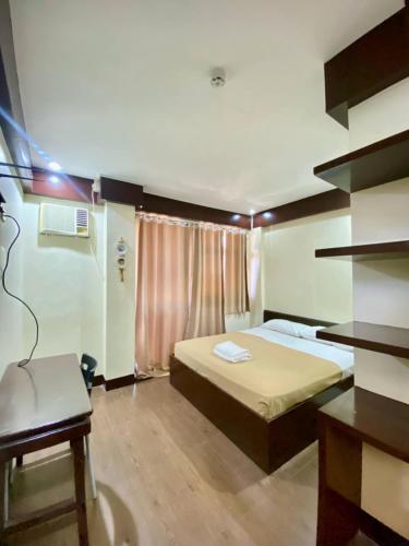 a small room with a bed and a chair at Sonly Hotel in General Santos