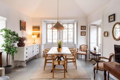 a living room with a table and chairs at Central Ericeira - Light filled with Terrace in Ericeira