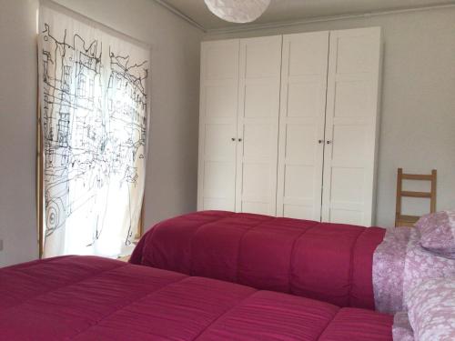 a bedroom with a purple bed and a window at Casa centro storico Rieti in Rieti