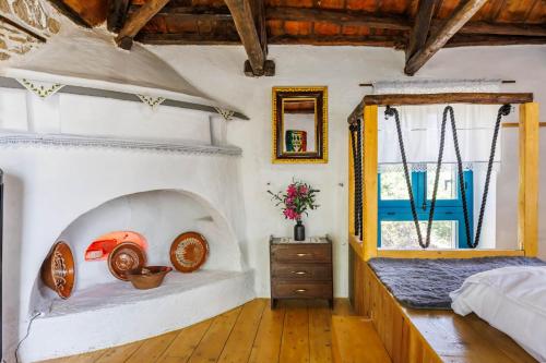 a bedroom with a bed and a window at Anatoli Peak Cottage in Skopelos Town