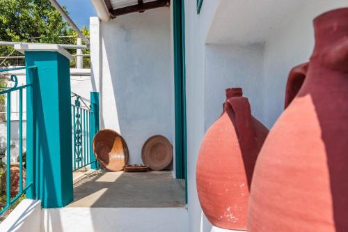 a group of vases sitting on the side of a building at Anatoli Peak Cottage in Skopelos Town