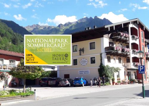 a sign on a street in front of a building at Apart-Pension Oberreiter in Fusch an der Glocknerstraße