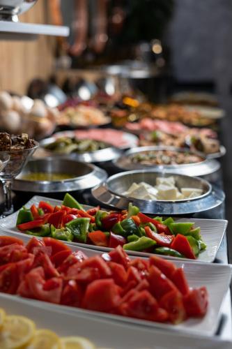 a buffet with many plates of food on a table at Marmaris Saray hotel NEW in Tashkent