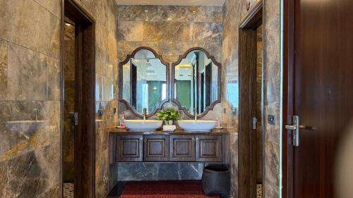 a bathroom with three sinks with mirrors on the wall at Fansipan View Hotel in Sa Pa