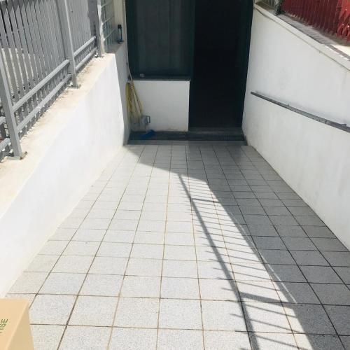 a hallway with a door and a tiled floor at Graziosa in Policoro