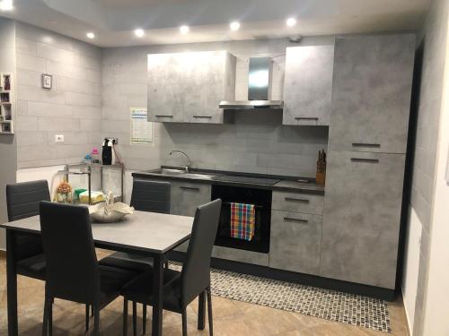 a kitchen with a table with chairs and a stove at Graziosa in Policoro