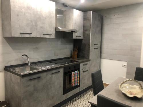 a kitchen with a sink and a stove top oven at Graziosa in Policoro