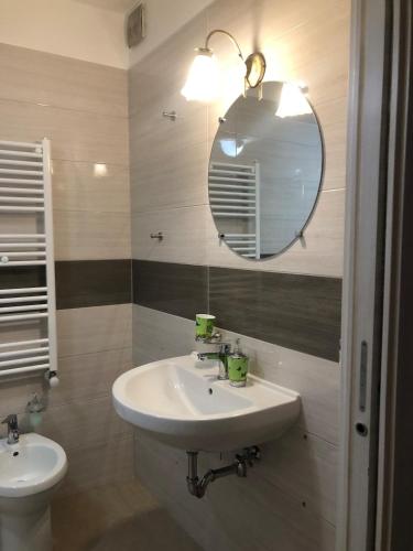 a bathroom with a sink and a mirror at Graziosa in Policoro