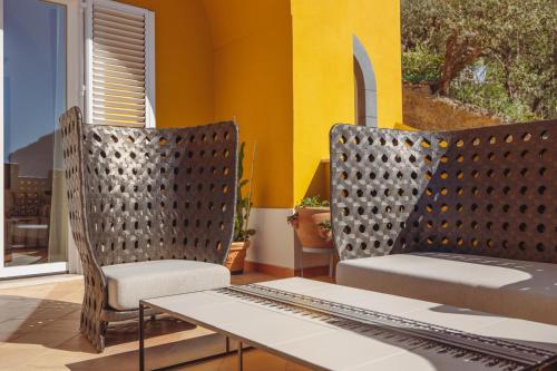 two chairs and a table in a room at Five Positano in Positano