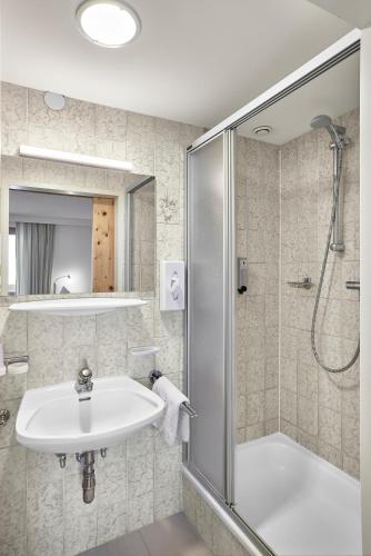 a bathroom with a sink and a shower at Bio Hotel Stillebach in Sankt Leonhard im Pitztal