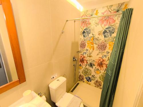 a bathroom with a shower and a toilet with a shower curtain at Taletos Apartments in Stoupa