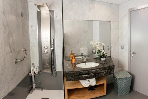 a bathroom with a sink and a shower at Sun Island Apartments in Funchal