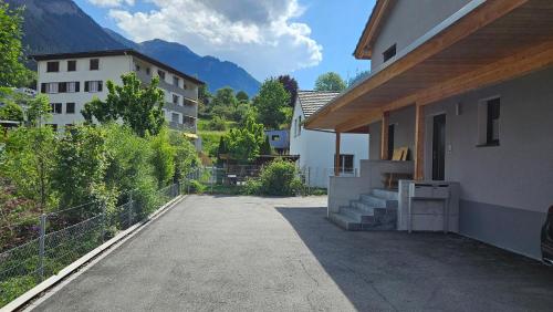 a building with a driveway next to a building at Appartement Ersalin im schönen Domleschg in Sils im Domleschg