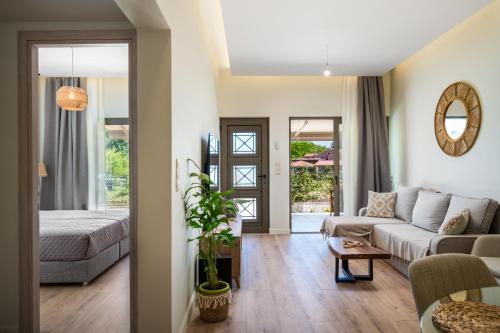 een woonkamer met een bank en een tafel bij Phos Elegant Residences by Konnect, 400m to the beach in Dassia