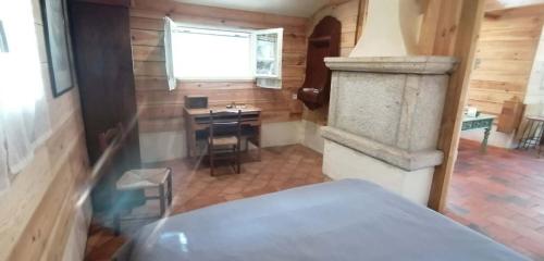 a view of a room with a table and a bed at La palombière in Saint-Symphorien