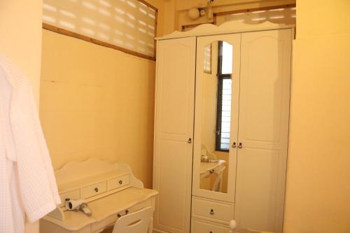a bathroom with a sink and a toilet and a mirror at Eco House in Bangkok