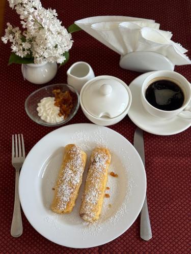 two pieces of bread on a plate on a table at Autopark Hotel in Lviv