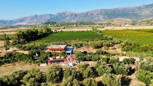 an aerial view of a farm with mountains in the background at Kantina & Ferma Dukat in Vlorë