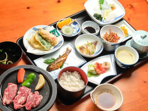 a tray filled with different types of food on a table at 国民宿舎古岩屋荘 in Higashi-komi