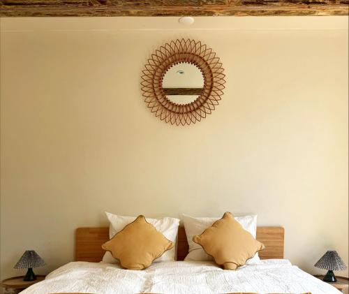 a bedroom with a bed with a mirror on the wall at The Hazel House in Haarlem