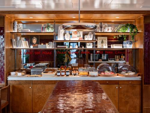 a bakery counter with a lot of food at Hôtel La Conversation in Paris