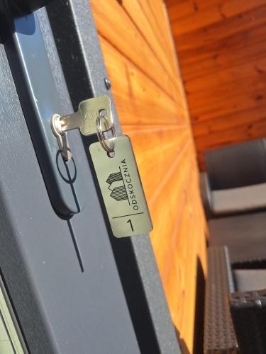a lock on a door with a key on it at ODSKOCZNIA Rewa in Rewa