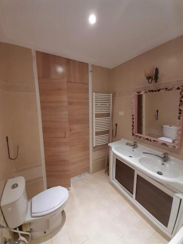 a bathroom with a toilet and a sink and a mirror at 120m2 House, Tunisia in Bin Rhilouf
