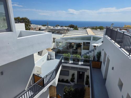 an aerial view of a building with the ocean in the background at Tataki Family Hotel in Fira