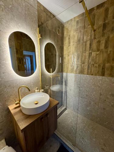 a bathroom with a sink and a shower at Panorama View Deluxe Apartment in Veszprém