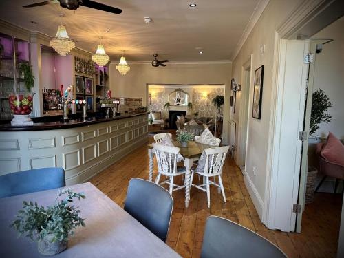 a kitchen and dining room with a table and chairs at Slepe Hall Hotel in St Ives