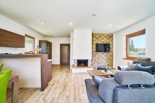 a living room with a couch and a fireplace at Chalupa na Lipně - Holiday House 1 in Lipno nad Vltavou