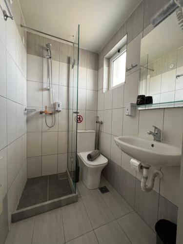 a bathroom with a shower and a toilet and a sink at Emi Seaside in Amoudara Herakliou
