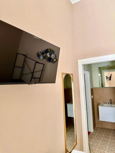 a bathroom with a mirror and a sink at Dimora Aquae Suites&Spa in Mola di Bari