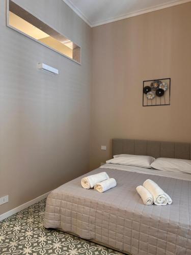 a bedroom with two beds with towels on them at Dimora Aquae Suites&Spa in Mola di Bari