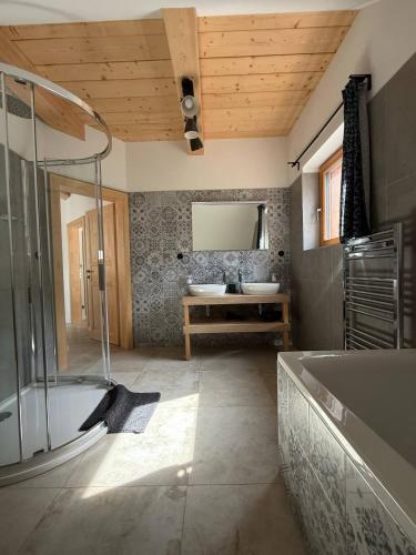 a bathroom with a bath tub and a sink at Chata Pluskacka in Velké Karlovice