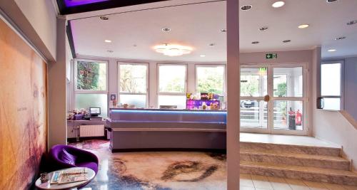 a large bathroom with a blue tub in a room at PLAZA INN stays design Dortmund in Dortmund