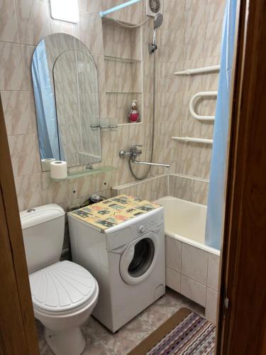 a bathroom with a toilet and a washing machine at Квартира в центрі на Волі 8А in Luts'k