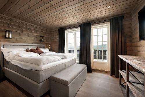 a bedroom with a large bed and a large window at Skyline Lodge in Stryn
