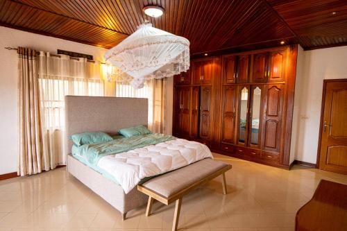 a bedroom with a bed and a chandelier at Kacyiru House Golf Course Views in Kigali