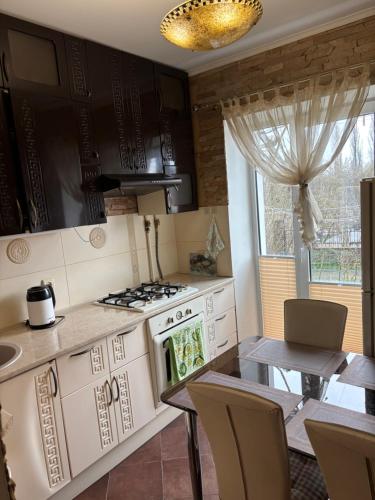 a kitchen with a table and a stove top oven at Квартира в центрі на Волі 8А in Luts'k