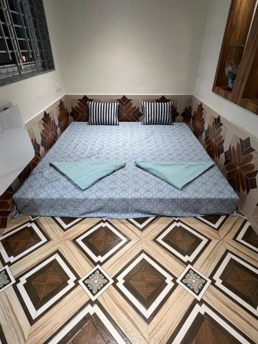 a bed sitting on top of a wooden floor at Zuluk Poolside Luxury Homestay with Swimming Pool in Ratnagiri