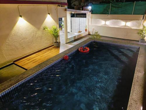 a large swimming pool in a building at Zuluk Poolside Luxury Homestay with Swimming Pool in Ratnagiri
