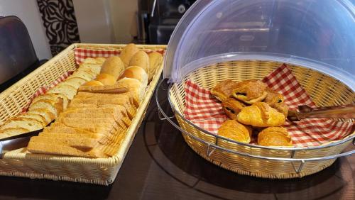 two baskets of bread and pastries on a table at Pension 2Be in Nafplio