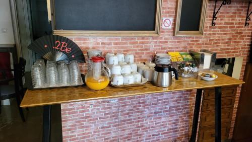 a wooden counter with bottles of juice and drinks on it at Pension 2Be in Nafplio