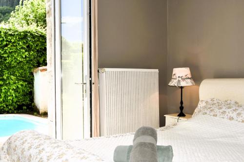 a person laying on a bed in a bedroom at La Maison de Lise in Cajarc