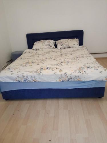 a bed with a blue bed frame in a room at Roam&Rest Sarajevo in Sarajevo
